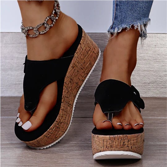 Cleo cork wedge flip flop sandal with bow detail at the toe strap, shown in black