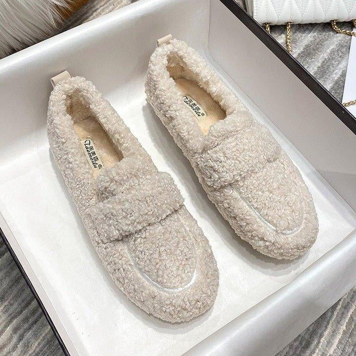 Close-up of soft plush lining inside cloud moc moccasin slipper in cream