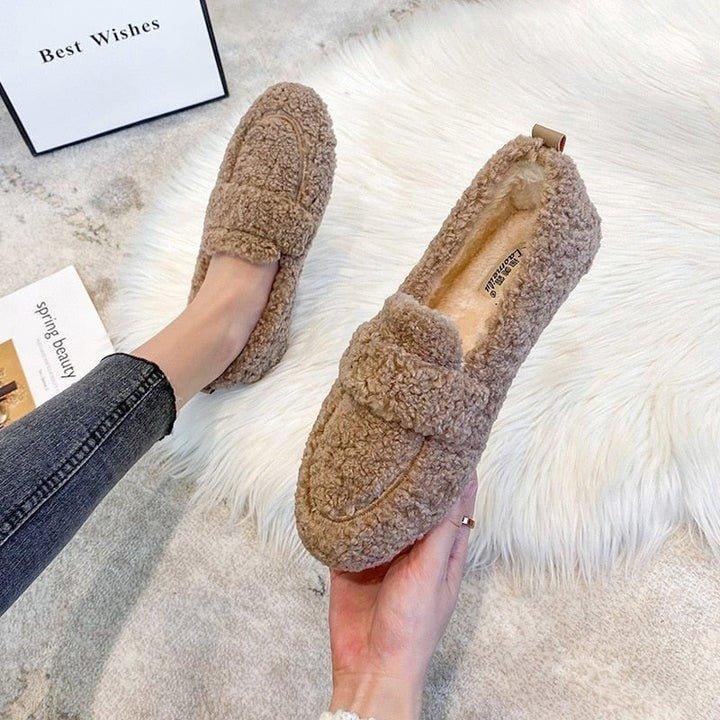 Side profile of cloud moc slipper showing refined moccasin silhouette in cream
