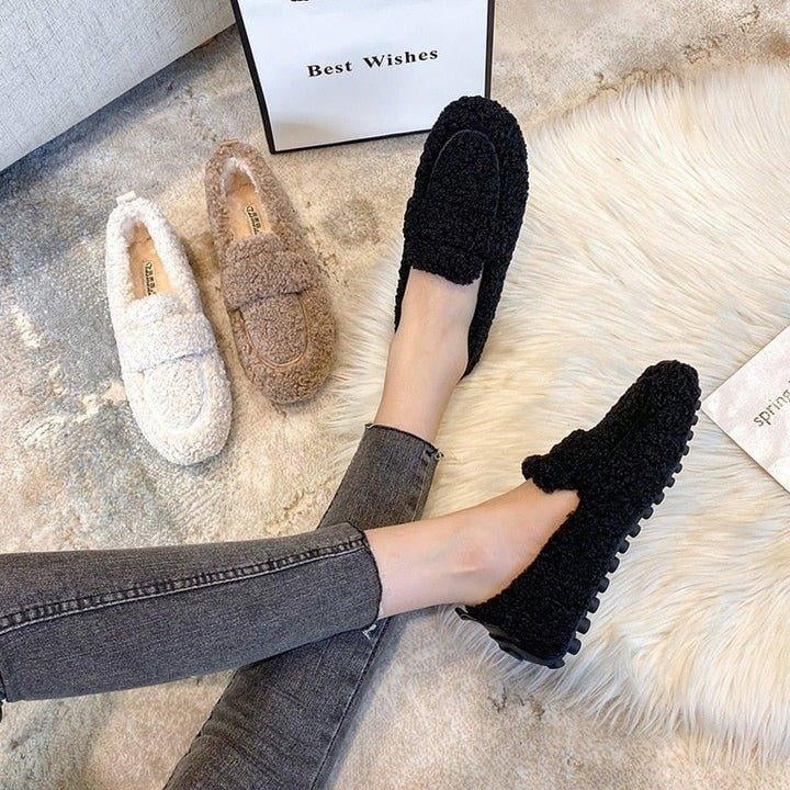 Woman wearing brown moccasin slippers while hosting guests at home