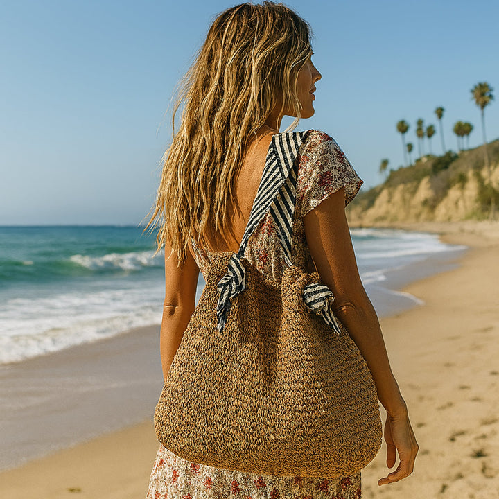 Warm brown handwoven boho shoulder bag with magnetic closure and bold shoulder strap, shown against a neutral background