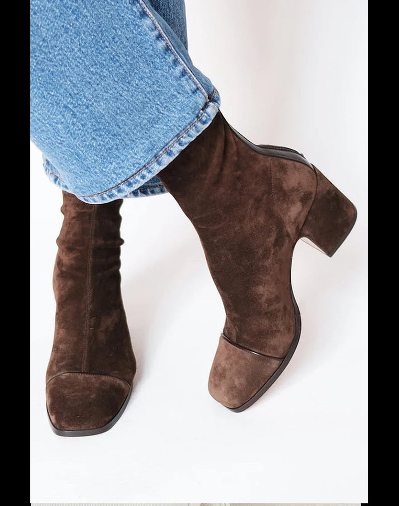 Dark brown orthopedic heeled boots shown from a front three-quarter angle, featuring a sleek heel and supportive structure