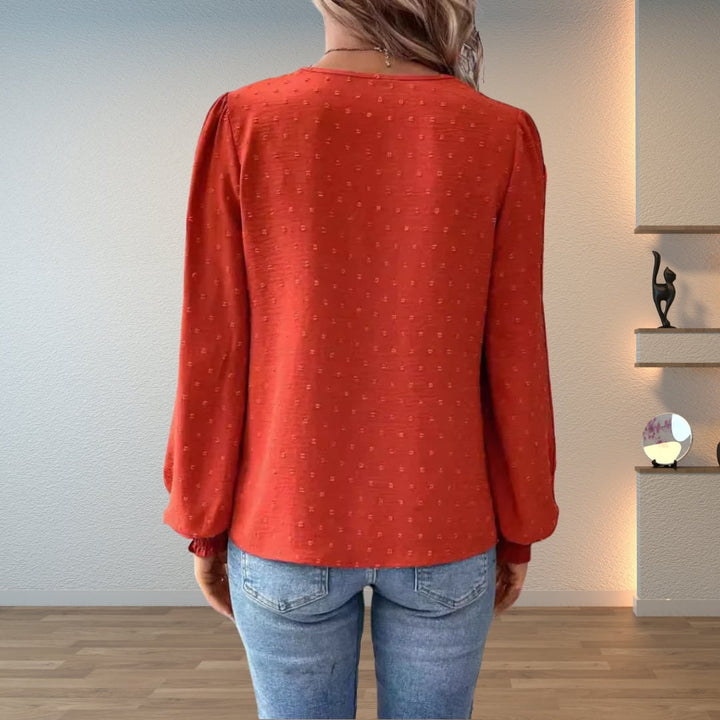 Front view of the Colette lightweight blouse in black, draped elegantly over the model's figure
