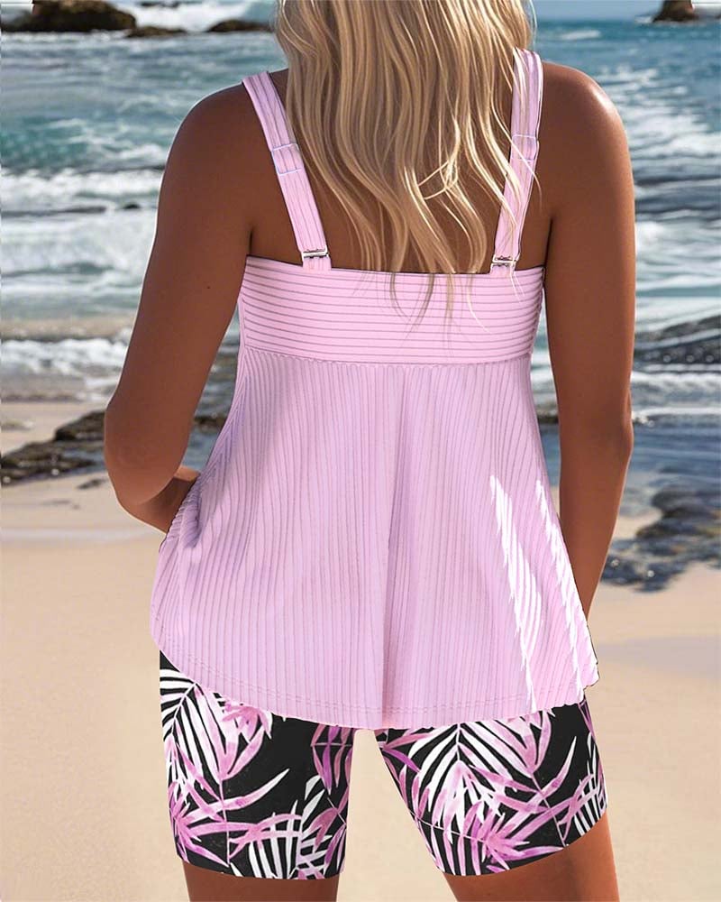 Model wearing the Colette printed tankini in pink styled with a sun hat