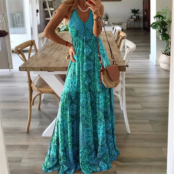 Woman wearing the Colette boho flowy V-neck maxi dress in green with spaghetti straps, full-length view