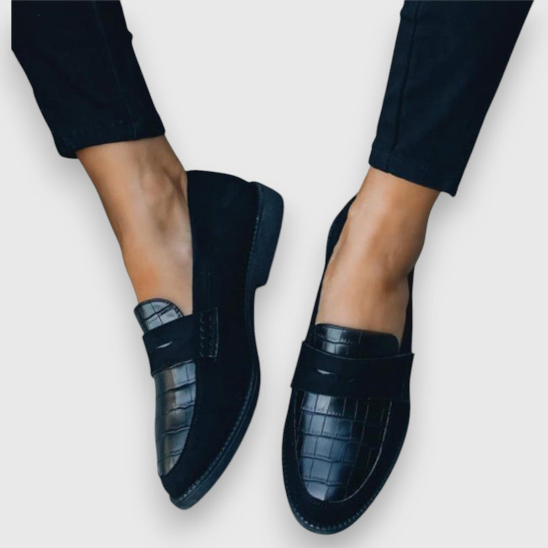 Front view of sleek flat slip-on loafers in a neutral tone, displayed on a clean white background