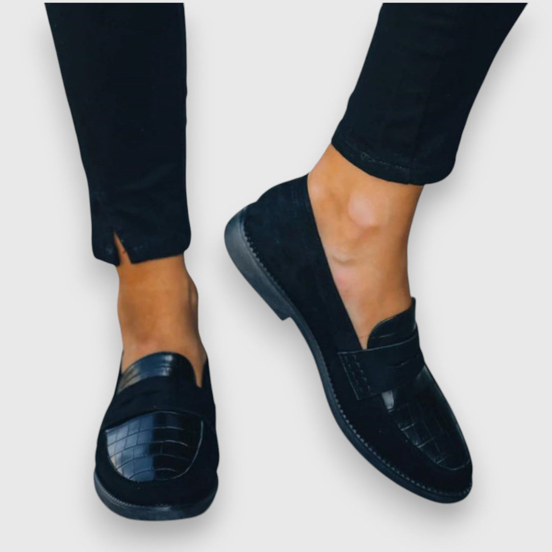 Side profile of elegant women's flat loafers showing refined silhouette and soft lining detail