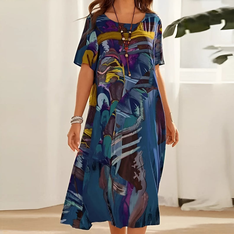 Woman wearing an elegant blue floral dress with a flowing silhouette, styled for a casual daytime look