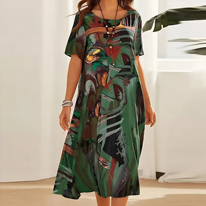 Front view of a green floral dress with soft fabric and feminine fit, shown on a model