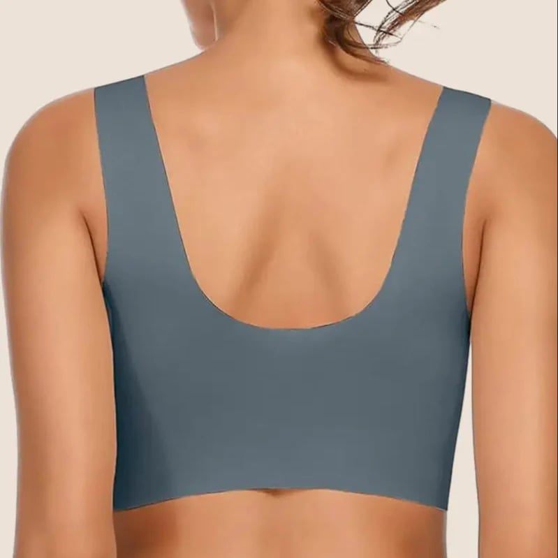 Model wearing black seamless bra under white fitted tee showing invisible seamless finish