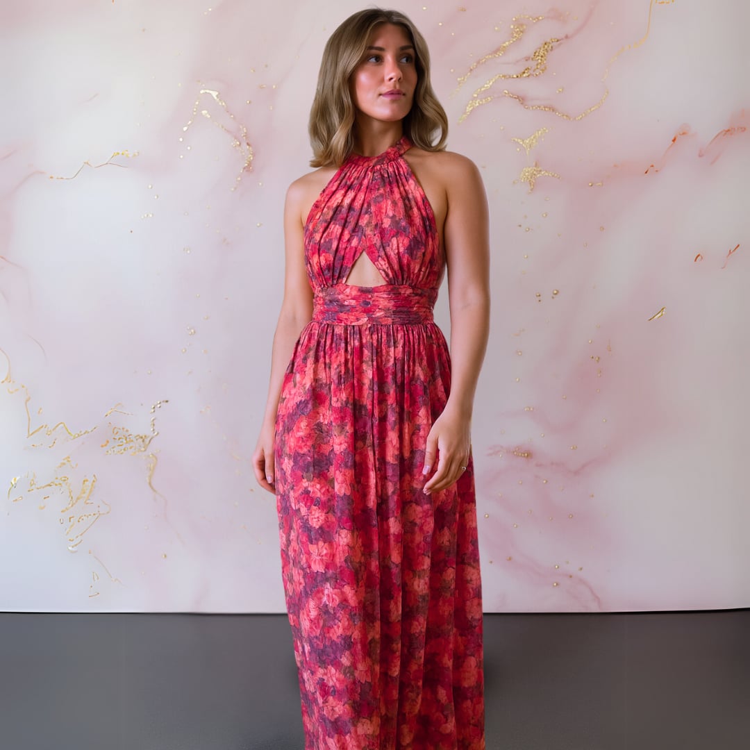 Close-up of red and pink floral print fabric on an elegant open-back maxi dress