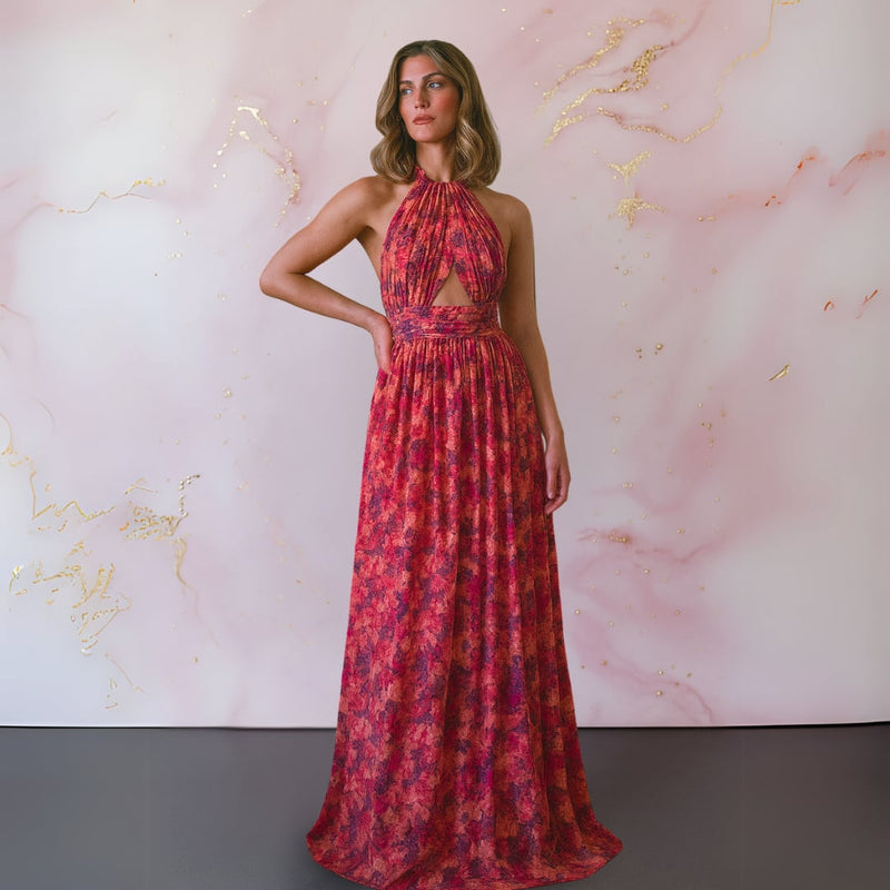 Full-length side view of a woman in a flowing red and pink floral maxi dress