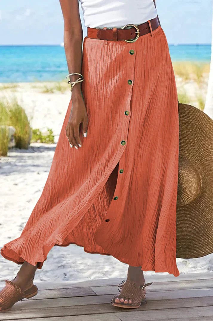 Front view of a high-waist button-front linen-look maxi skirt in mandarin red with a flowing floor-length hem
