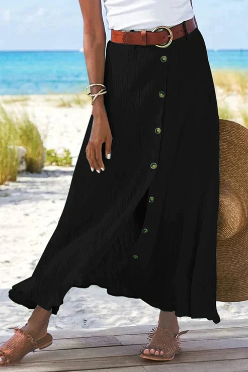 Close-up of the structured high waistband and button-front placket on the linen-look maxi skirt