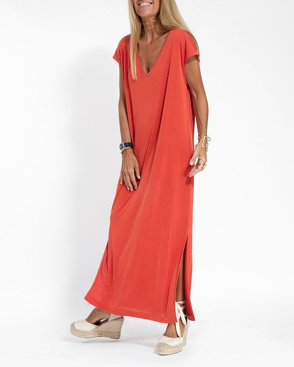 Side view of women's red cap sleeve maxi dress highlighting the high side slit