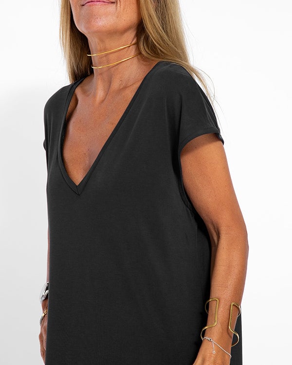 Side view of women's black cap sleeve maxi dress showing length and slit detail