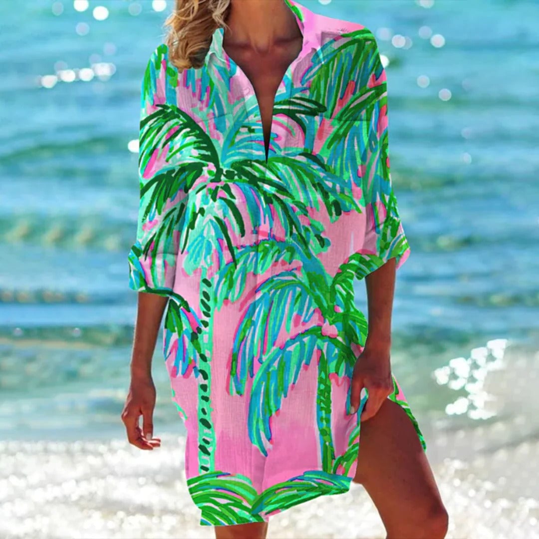 Back view of the Coralie tropical print shirt dress in pink highlighting the relaxed midi length