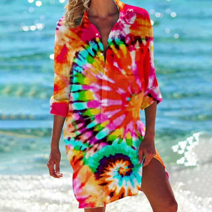 Flat lay of the Coralie tropical print shirt dress showing the all-over watercolor print and shirt collar