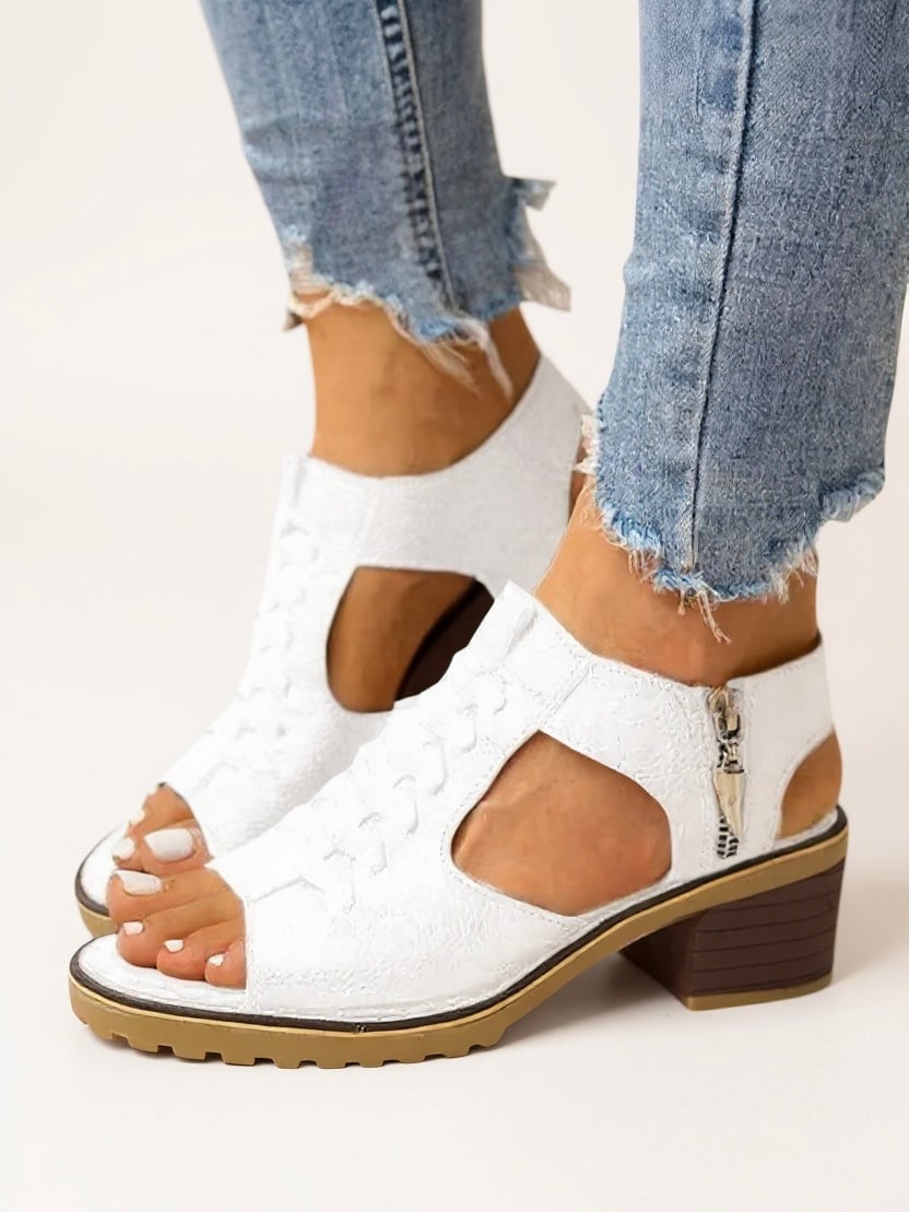 Cordelia block heel sandals in black showing zip fastening detail and stable heel, front angle view