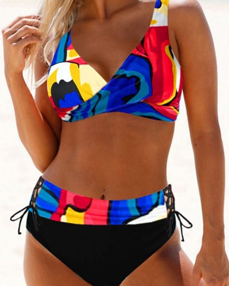 Model in the Cordelia bikini set in black posed on a sandy beach