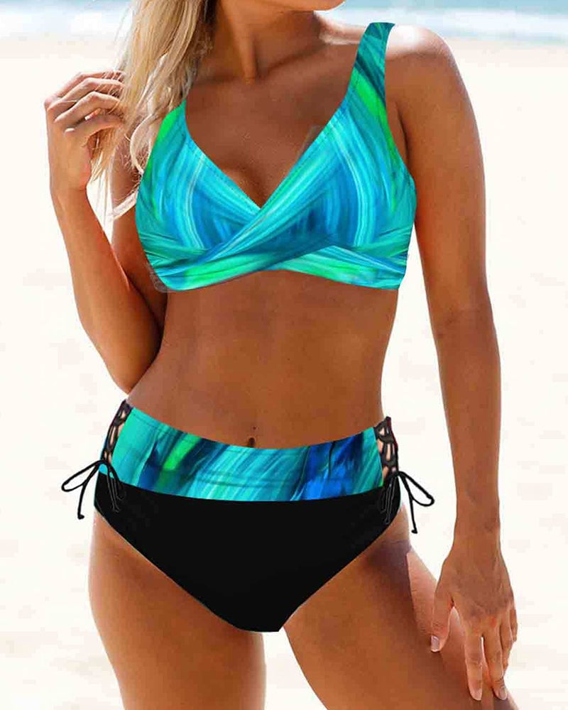 Model smiling in the Cordelia bikini set in green in a poolside setting