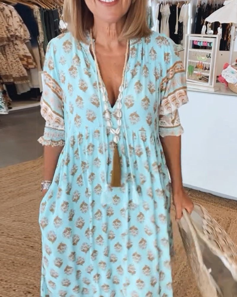 Model wearing Cordelia floral dress in blue styled with heels