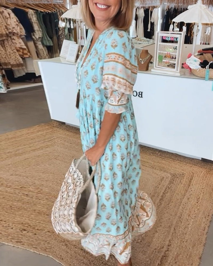 Cordelia floral V-neck dress in blue shown in natural light outdoors