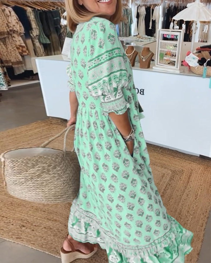 Back view of Cordelia floral flowy dress in green showing graceful drape