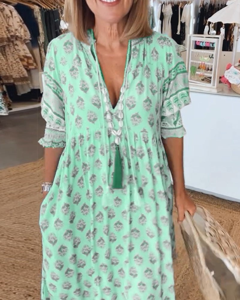 Model wearing Cordelia floral dress in pink styled with wedges