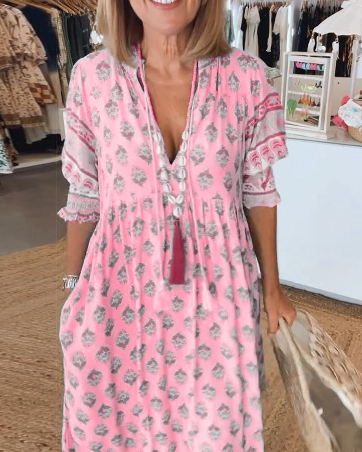 Flat lay of Cordelia floral dress in pink highlighting print and fabric texture