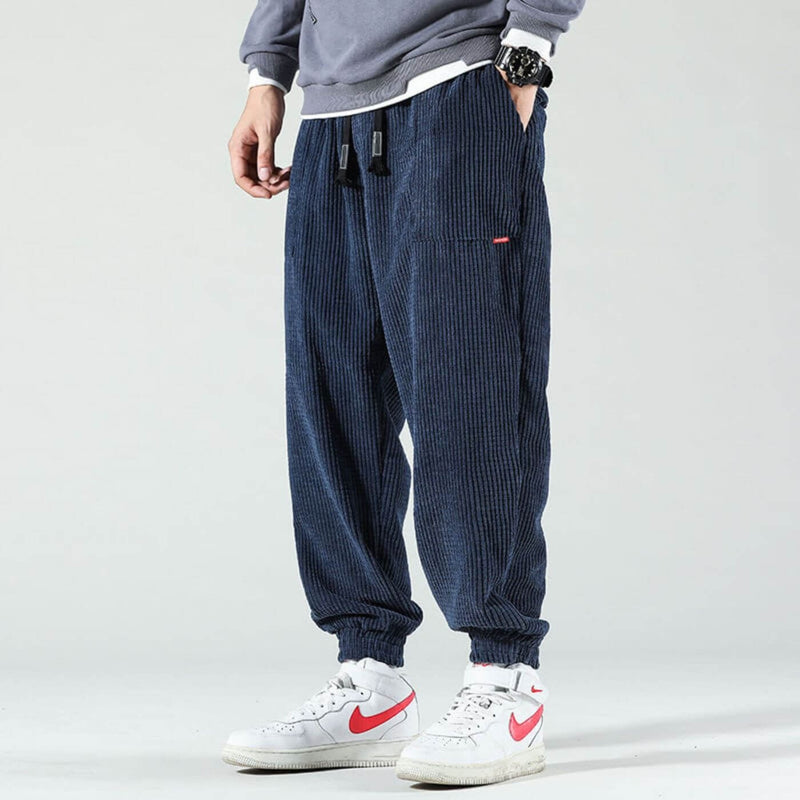 Model wearing marine blue classic corduroy joggers with a relaxed fit and tapered leg