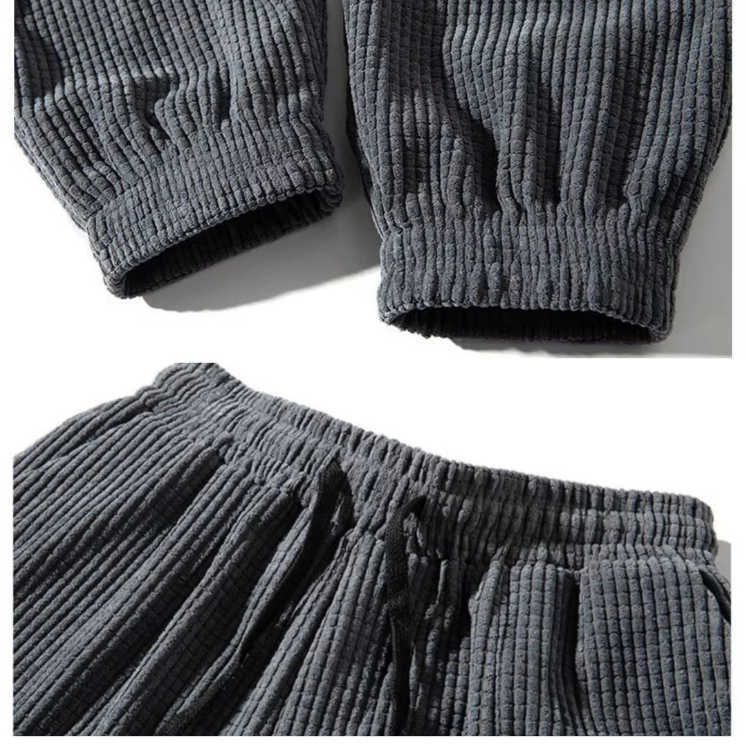 Black corduroy joggers worn with a fitted blouse for a polished, elevated everyday look