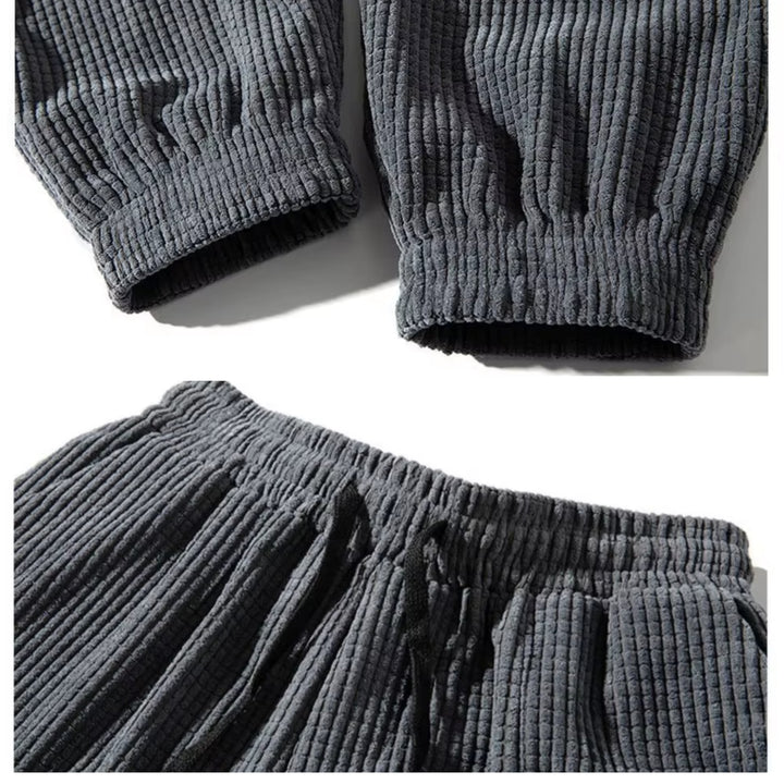 Black corduroy joggers worn with a fitted blouse for a polished, elevated everyday look