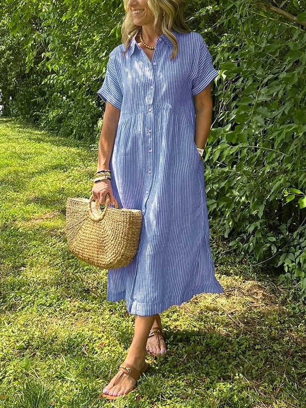 Model wearing a striped button-up long shirt with a tailored collar and flowing fit in blue