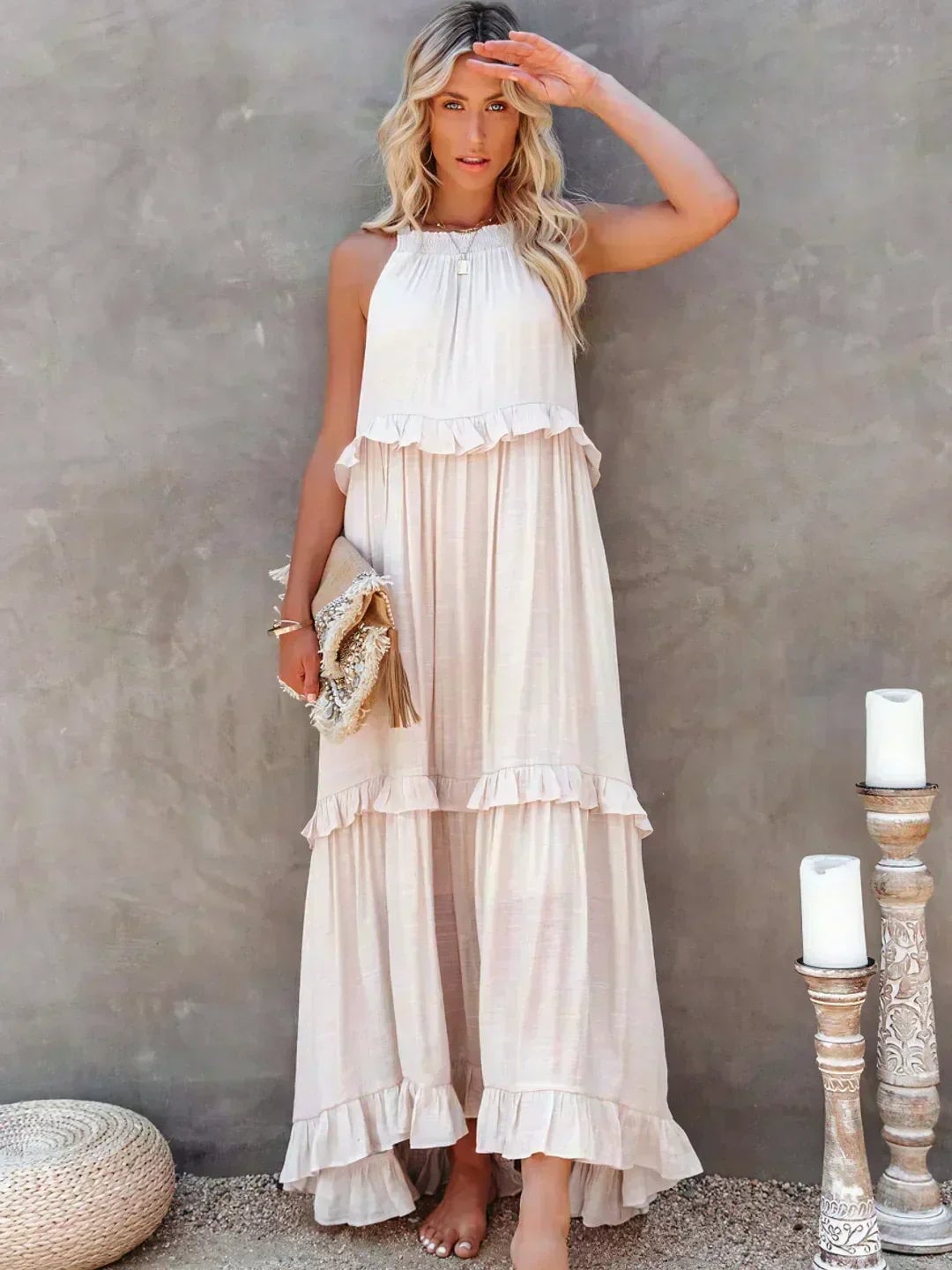 Woman wearing the Courtney elegant sleeveless ruffle dress in beige, showing flowing fit and delicate ruffle details