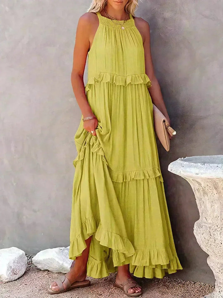 Side view of the Courtney sleeveless dress in yellow, showing dress length and ruffle movement