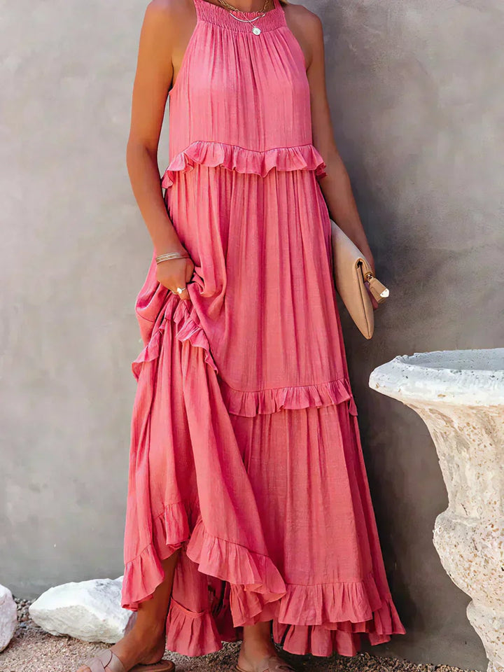 Model in the Courtney ruffle dress in red at a seaside setting