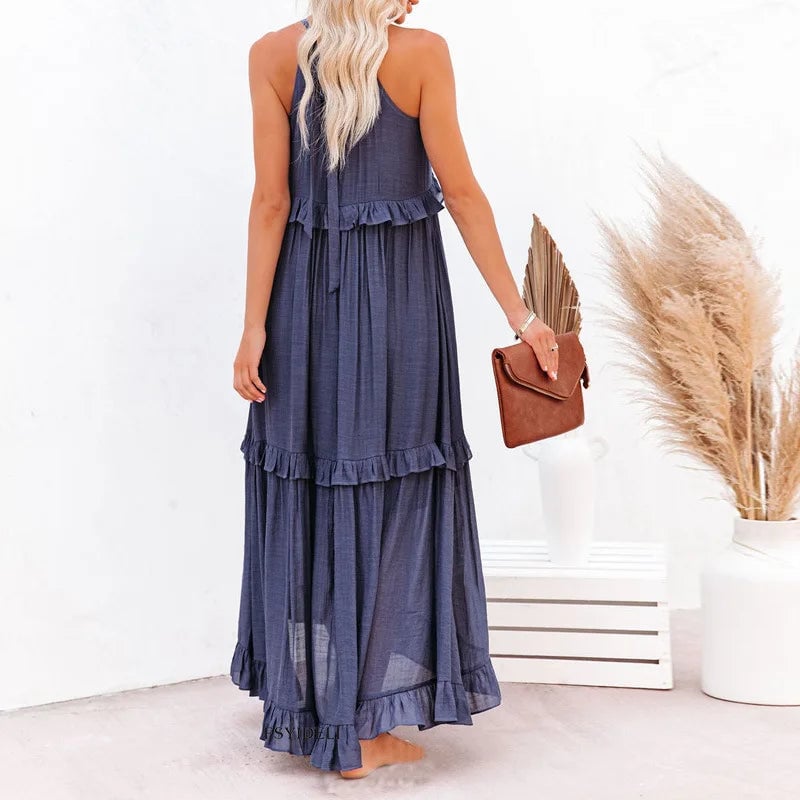 Model wearing the Courtney dress in dark blue paired with a woven tote for a casual day look