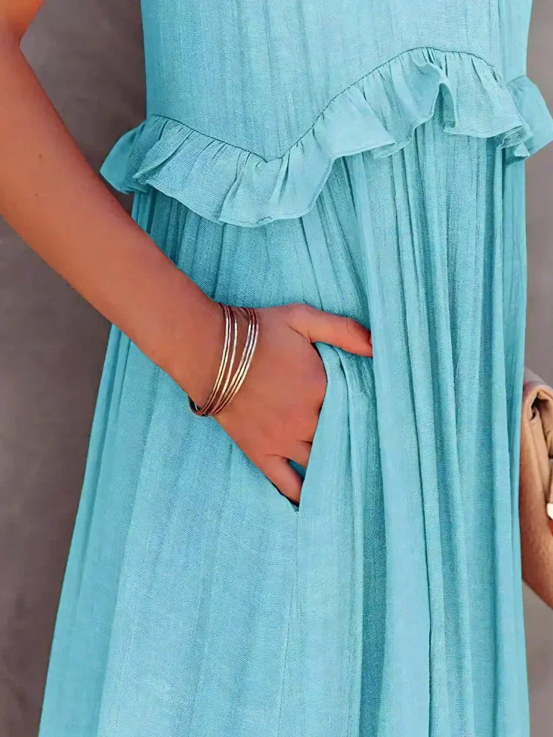 Courtney sleeveless ruffle dress in blue, close-up of hem and ruffle finish