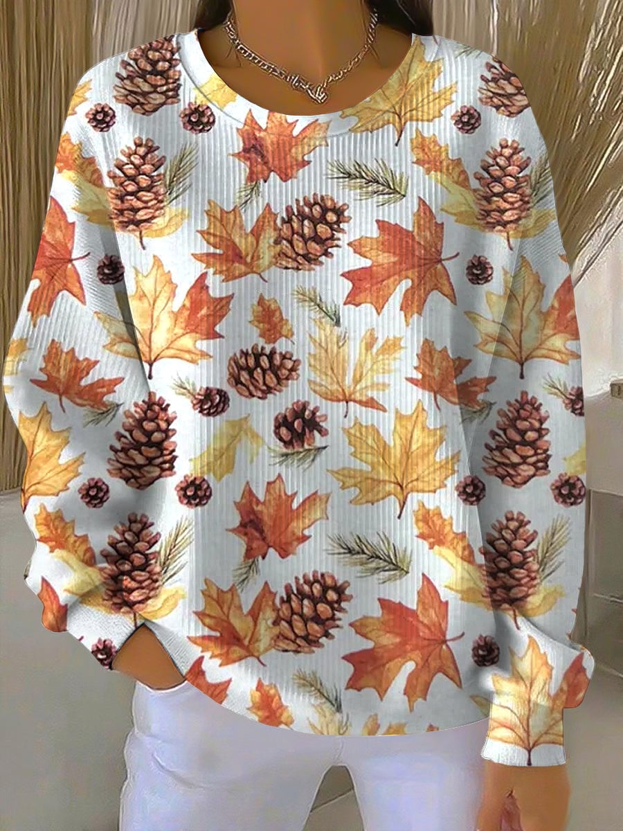 Woman wearing a cozy relaxed-fit sweatshirt featuring a colorful maple leaf print, perfect for fall casual outfits