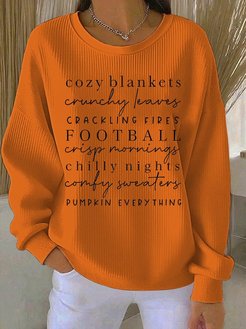 Model wearing a relaxed-fit orange cozy season sweatshirt with a charming fall seasonal graphic print