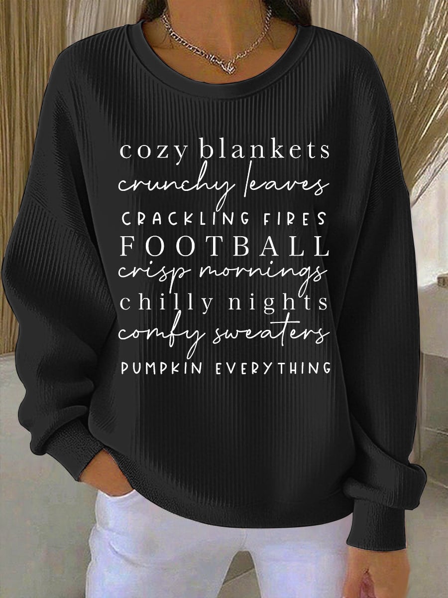 Close-up of the Cozy Season sweatshirt in black highlighting the soft cozy fabric and print quality