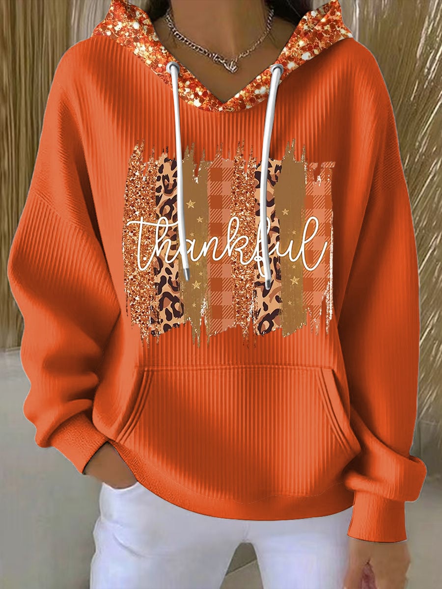 Woman wearing a cozy multicolor sequin hoodie with a relaxed fit, perfect for festive casual occasions