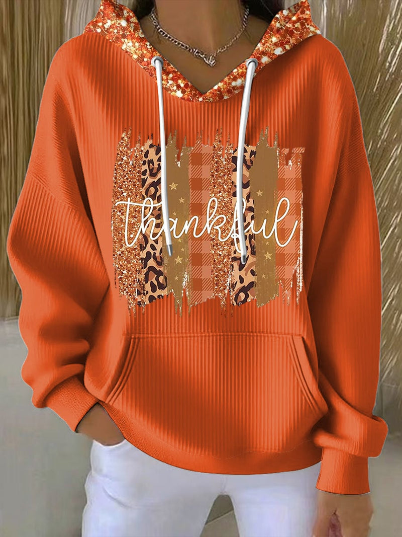 Woman wearing a cozy multicolor sequin hoodie with a relaxed fit, perfect for festive casual occasions