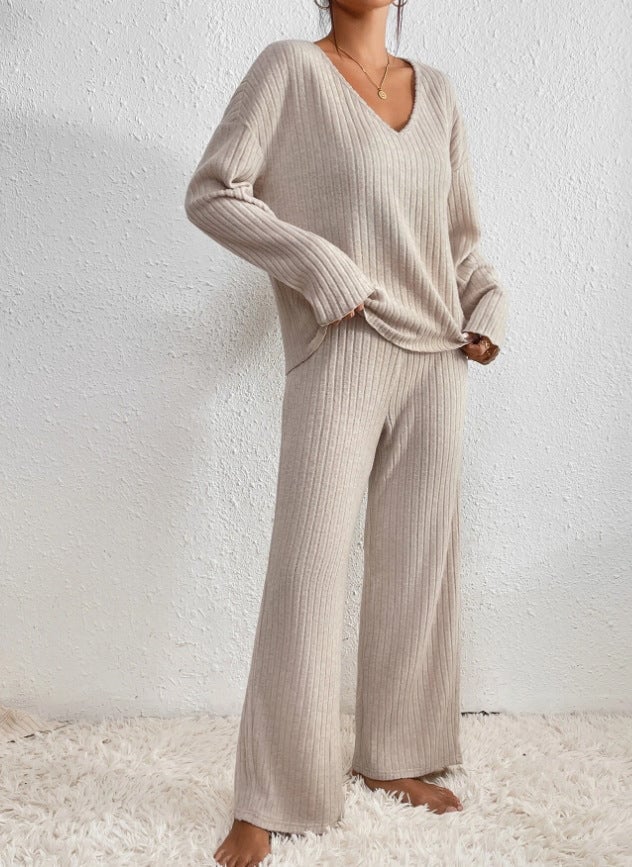 Full-length view of ribbed knit set in light brown showing relaxed fit trousers and V-neck sweater