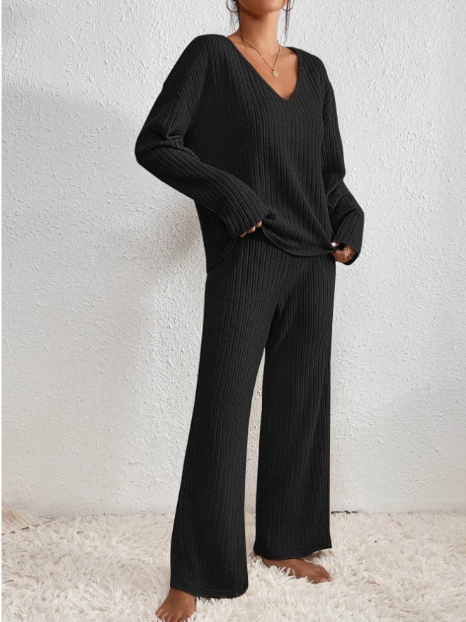 Model wearing ribbed knit set in beige, showcasing relaxed trouser fit