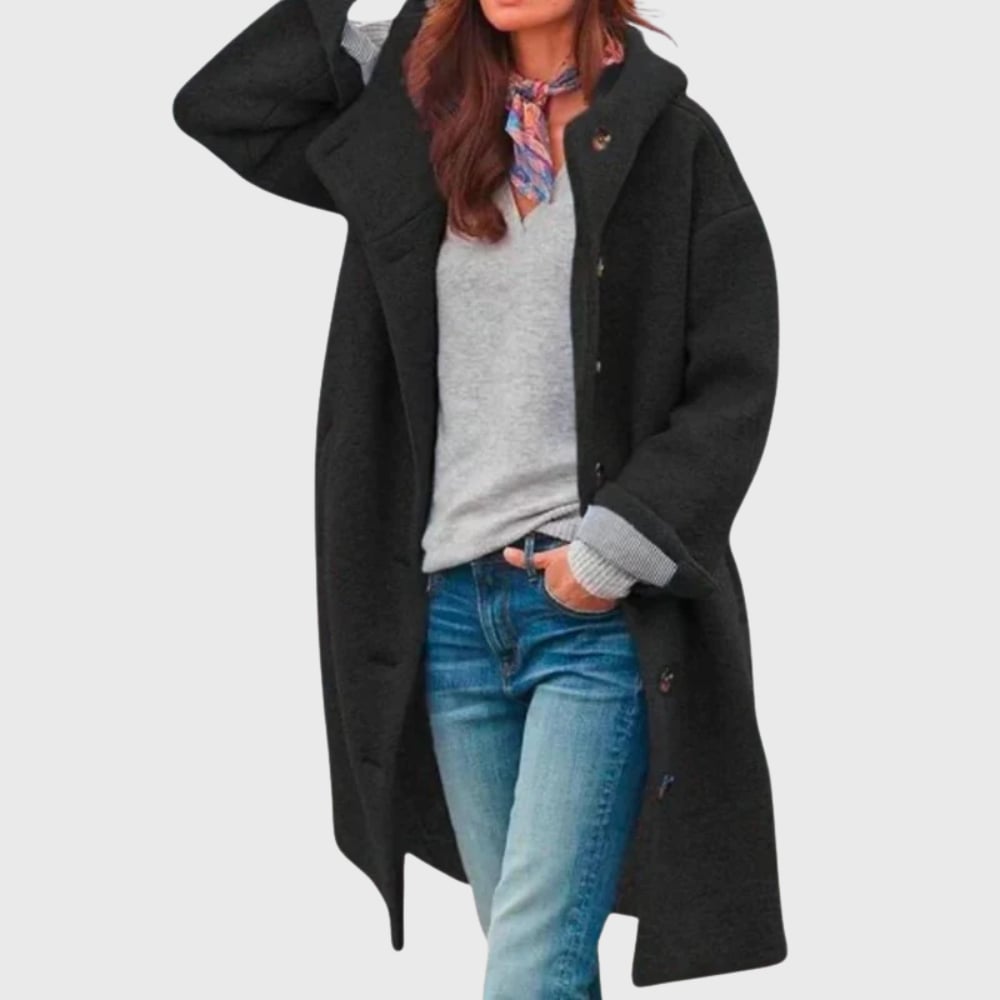 Woman styled in warm classic coat over casual outfit, side profile view