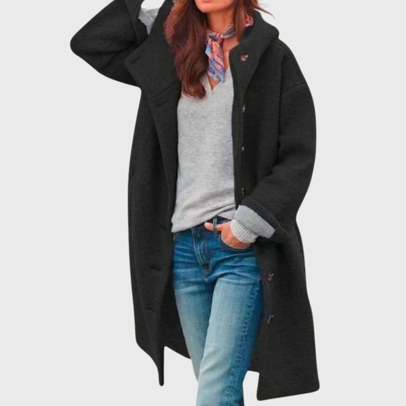 Woman styled in warm classic coat over casual outfit, side profile view