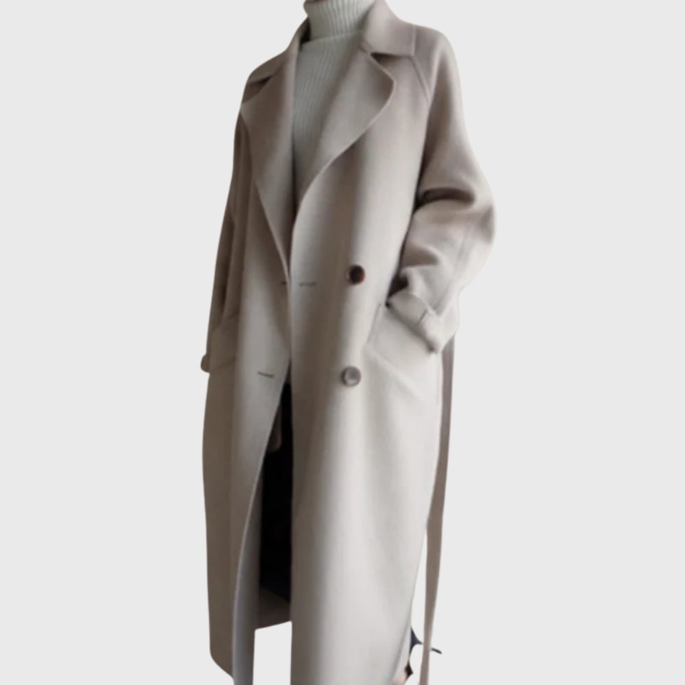 Model wearing a beige longline overcoat with a streamlined silhouette, front view