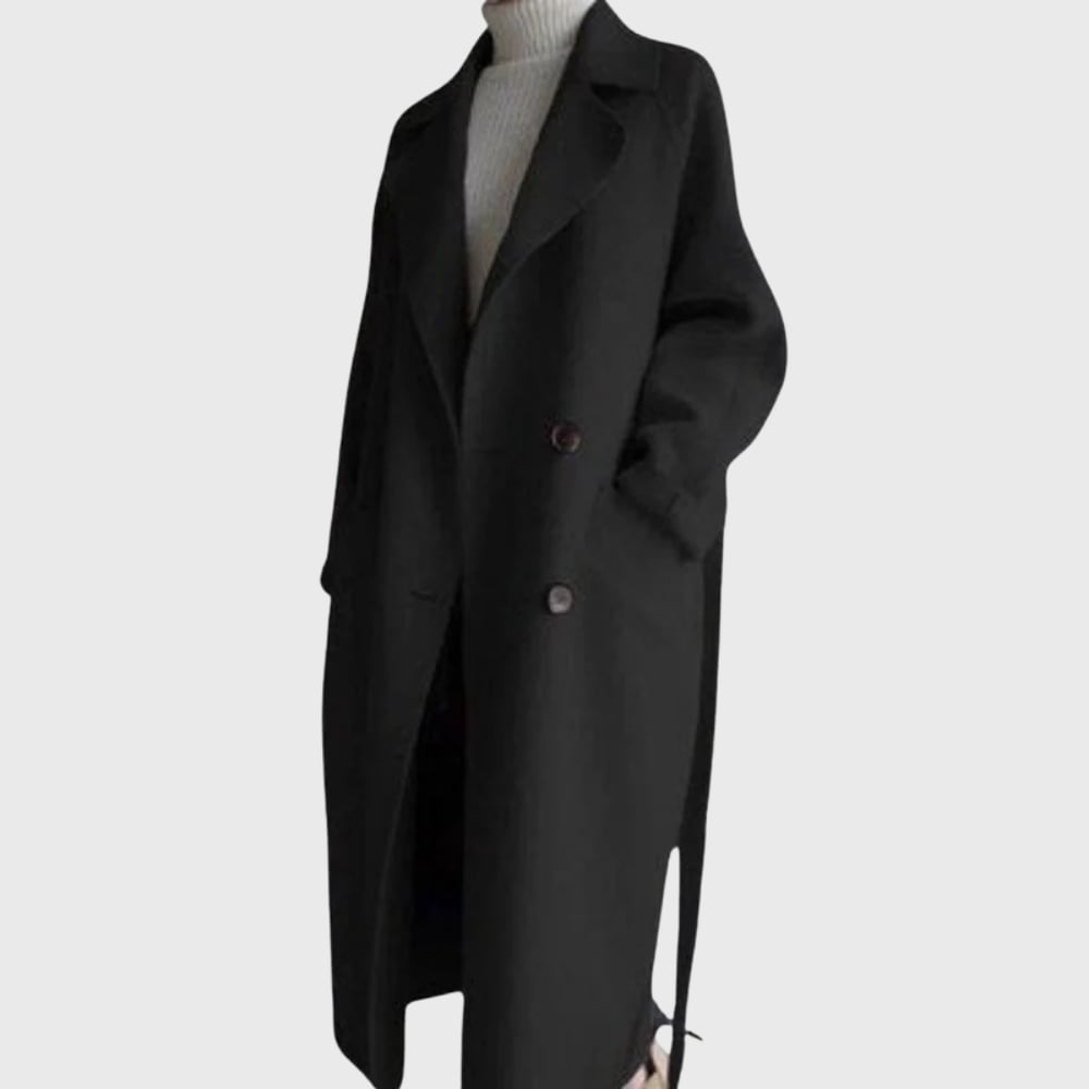 Model styled in a brown longline overcoat layered over a dress for an elevated look